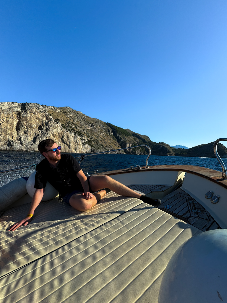 Sitting at the front of the boat with ocean views on the Amalfi Coast