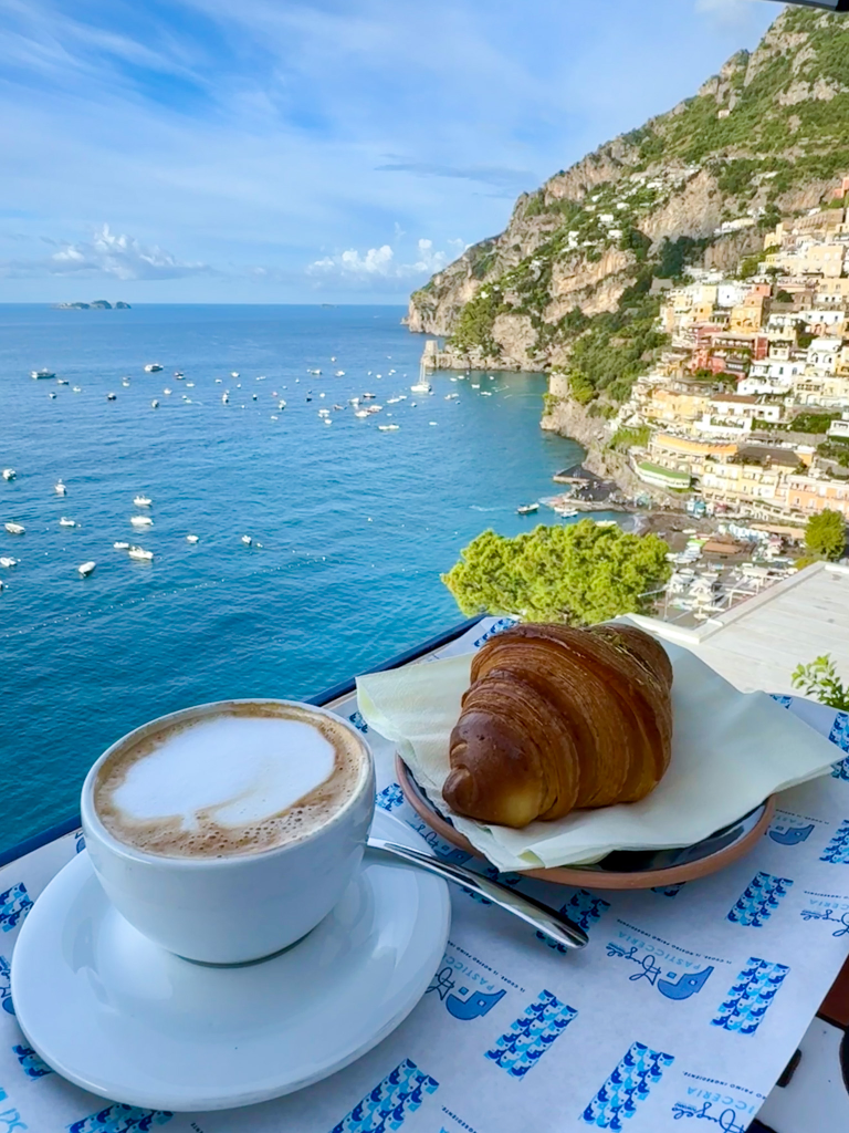 Cappuccino and cornetto with a sea view from Angelo Cafe in Positano