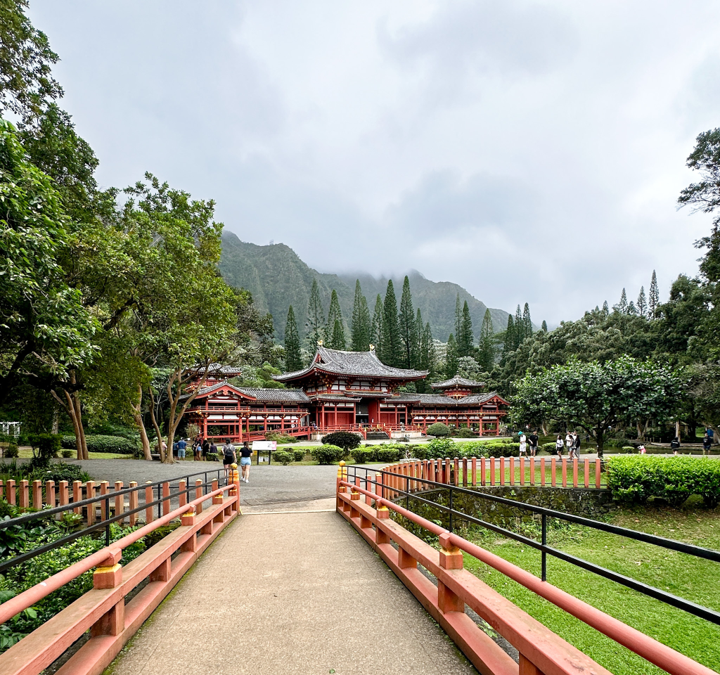 Scenic view of Byodo-In Temple, one of the best hidden gems in Oahu, with pond, gardens, and dramatic mountain backdrop