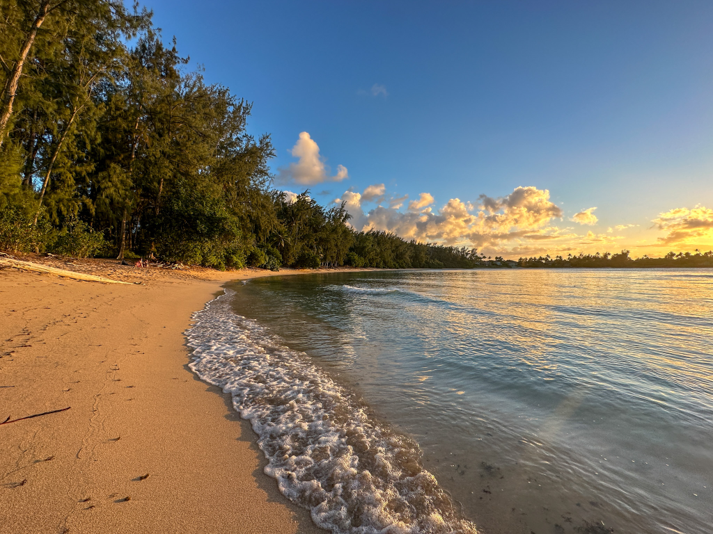 Calm shoreline and sunset views at Kawela Bay Beach on Oahu’s North Shore