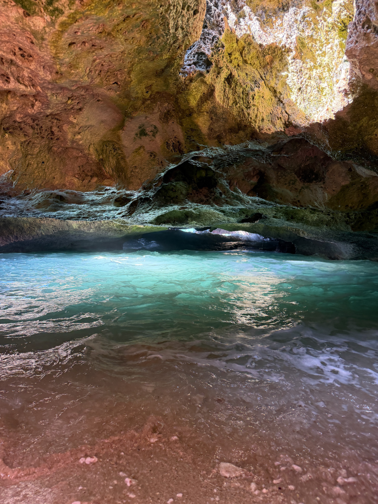 Sunlight shining into Mermaid Caves on Oahu over turquoise water