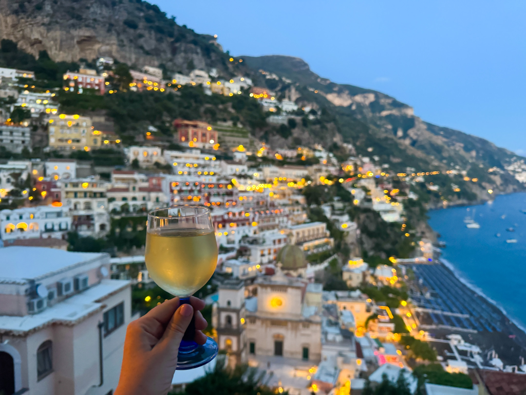 Rooftop drinks with a nighttime view over Positano