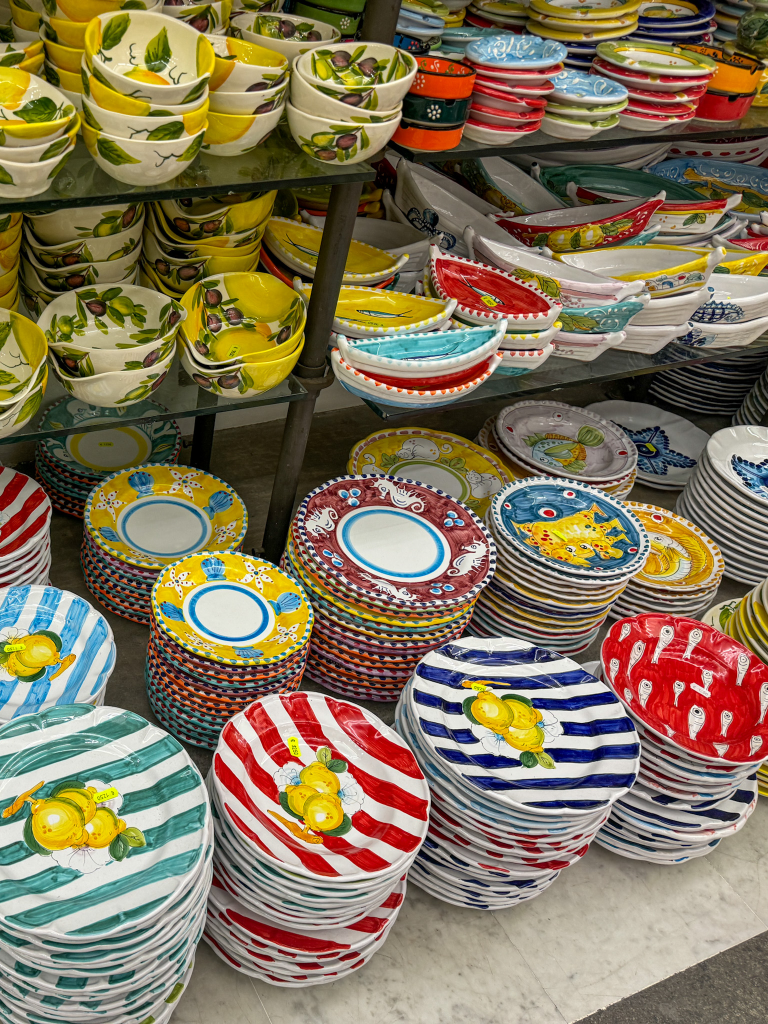 Colorful ceramic plates and bowls for sale in a shop in Sorrento