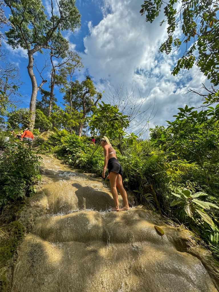 Climbing the limestone rocks at the Sticky Waterfall in Chiang Mai, Thailand